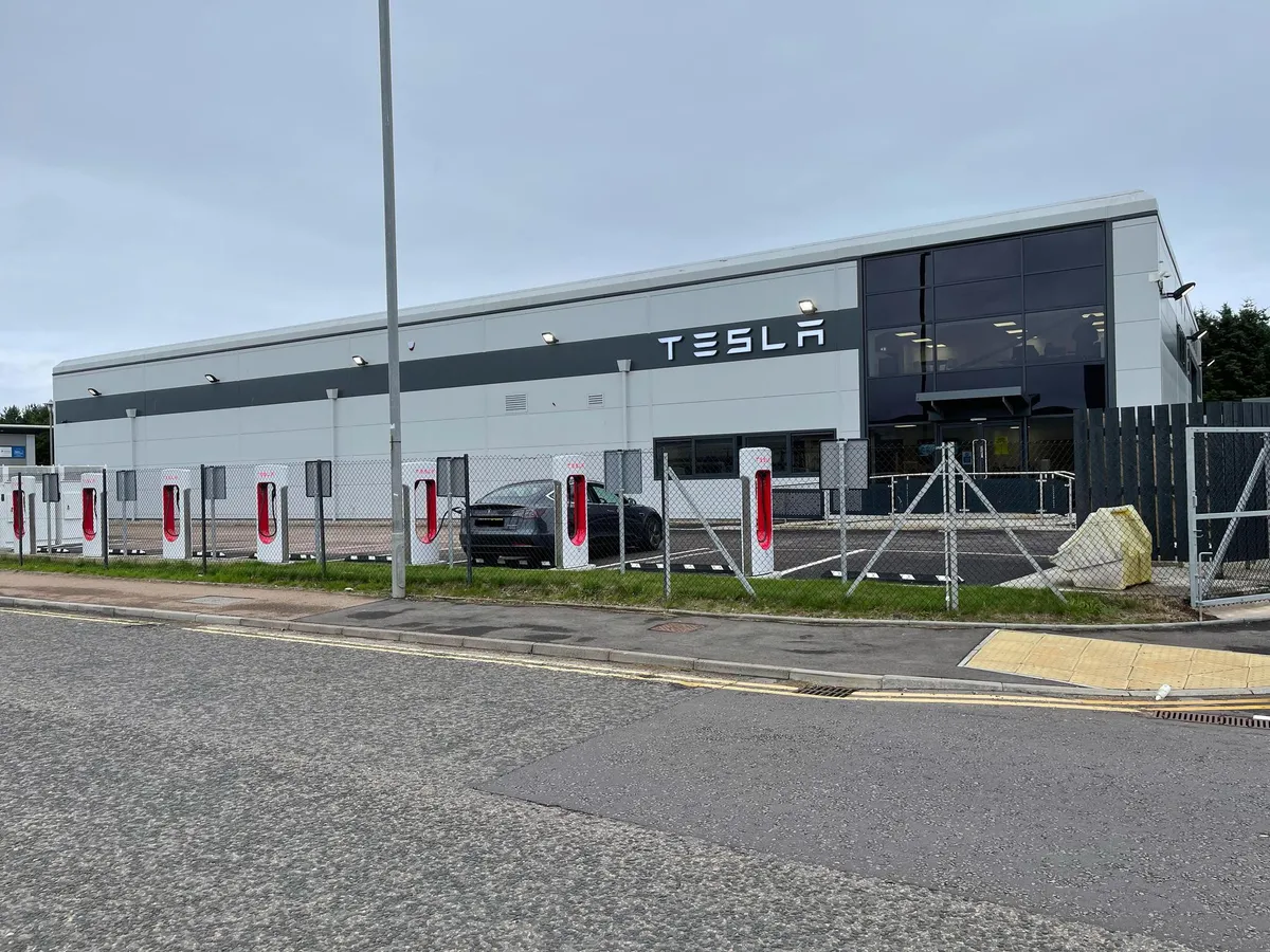 Tesla Centre Aberdeen service-centre building and Supercharger bays at Wellington Circle.