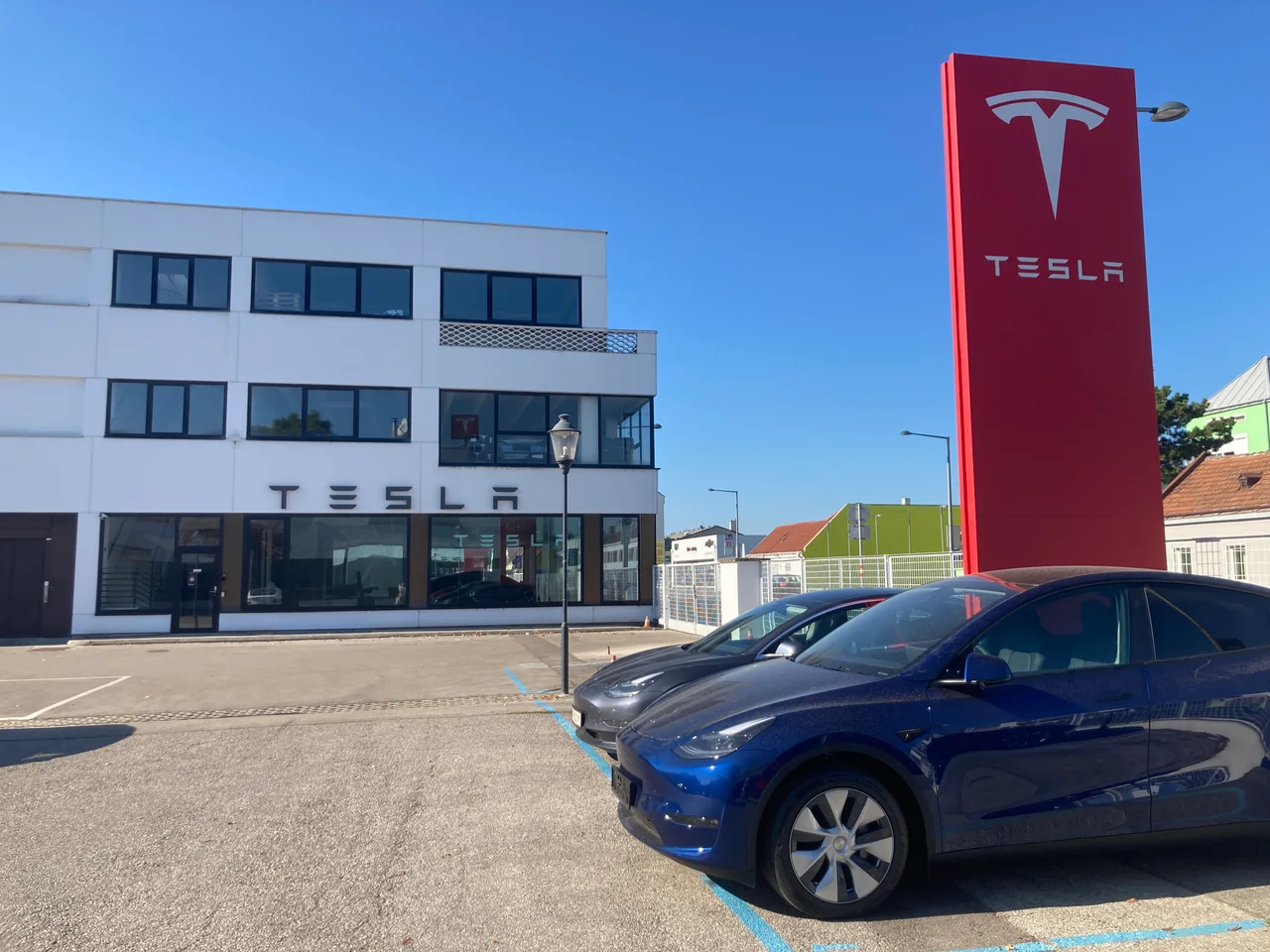 Фасад Tesla Center Wien Liesing и стела Tesla по адресу Triester Str. 207–209. Снимок сентября 2024 года.